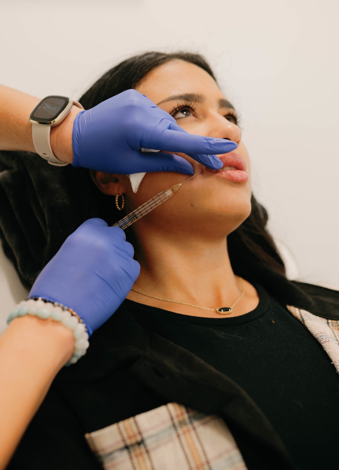 Instructor performing lip filler injection on a live model